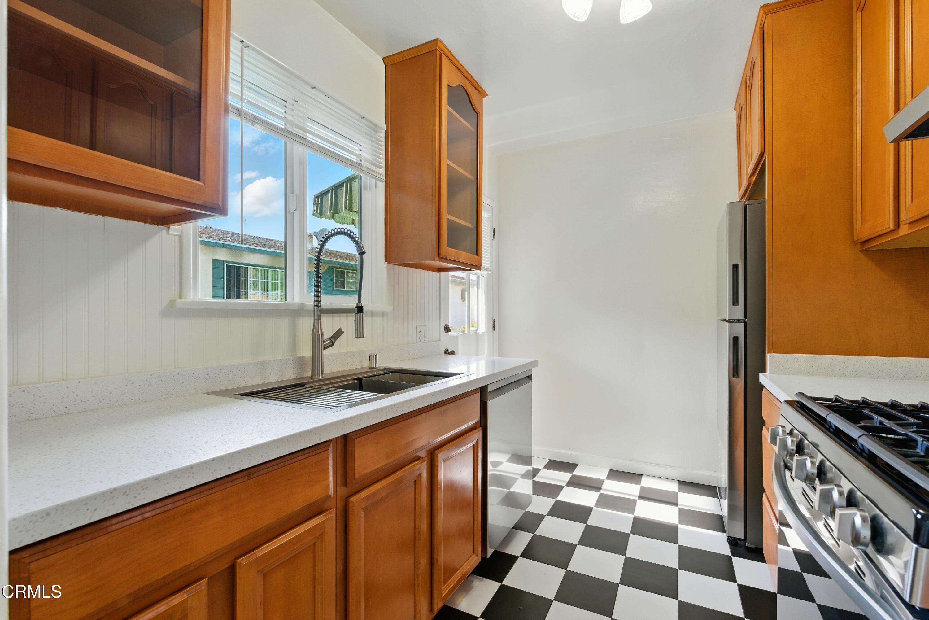 1545 Riverside Drive Glendale, CA 91201 - Photo 6 of 19 a kitchen with a sink a stove and a refrigerator