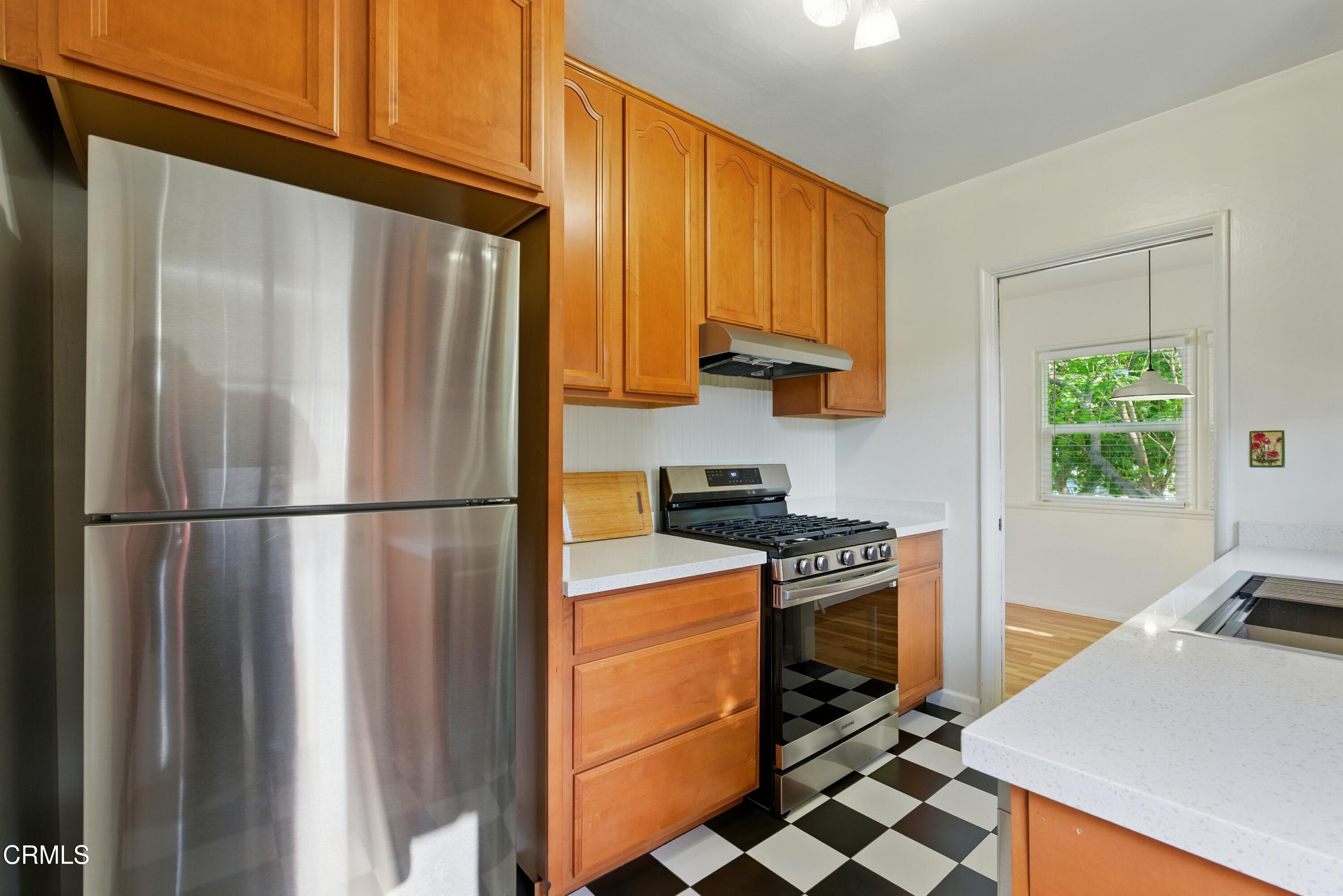 1545 Riverside Drive Glendale, CA 91201 - Photo 9 of 19 a kitchen with a refrigerator a stove a washer and dryer