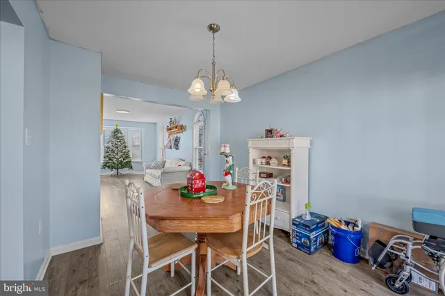 a view of a dining room with furniture and chandelier