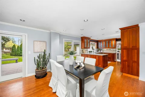 a dining room with furniture and wooden floor