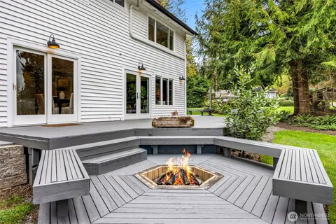 a view of backyard with deck and outdoor seating