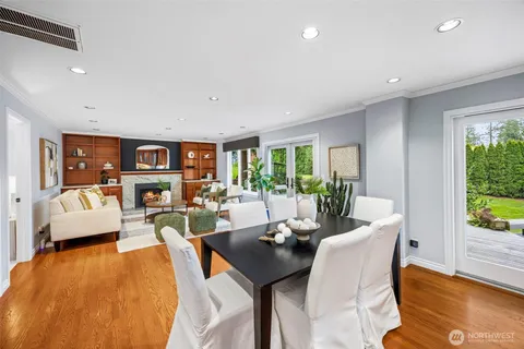 a living room with fireplace furniture and a large window
