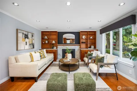 a living room with furniture large window and a fireplace