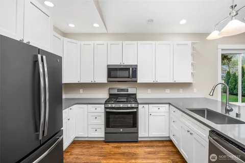 a living room with furniture wooden floor and a large window