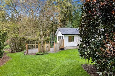 a view of a house with a yard and sitting area