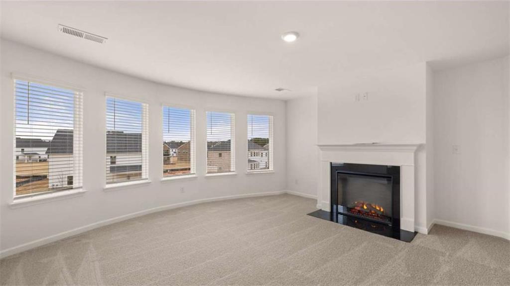 683 Edgar Hampton, GA 30228 - Photo 31 of 48 a view of an empty room with a fireplace and a window
