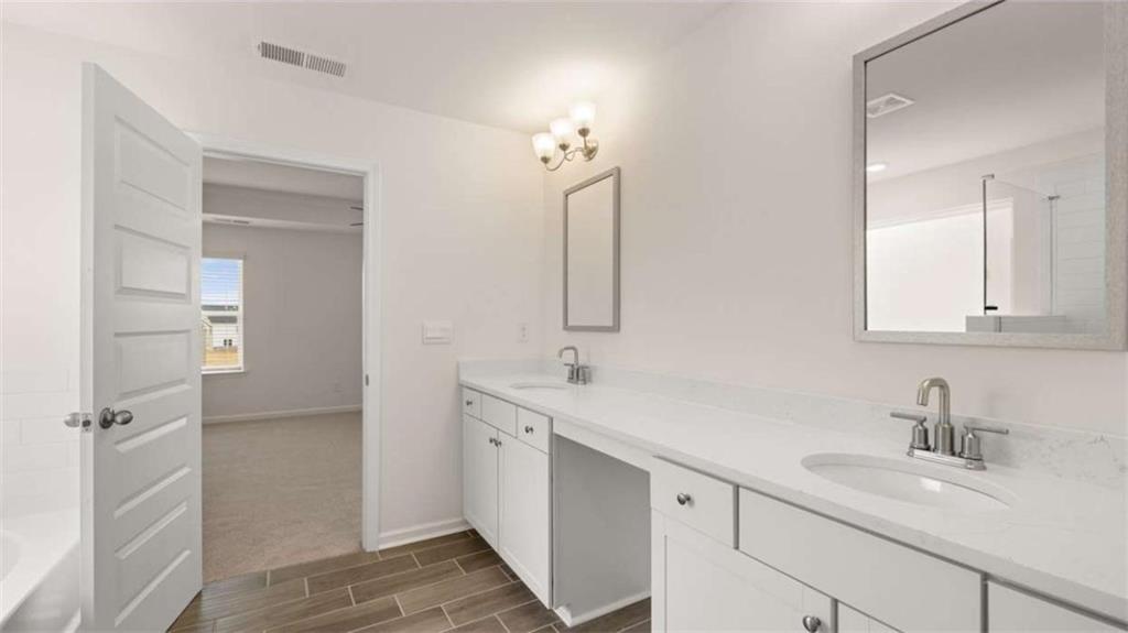683 Edgar Hampton, GA 30228 - Photo 34 of 48 a bathroom with a double vanity sink mirror and double