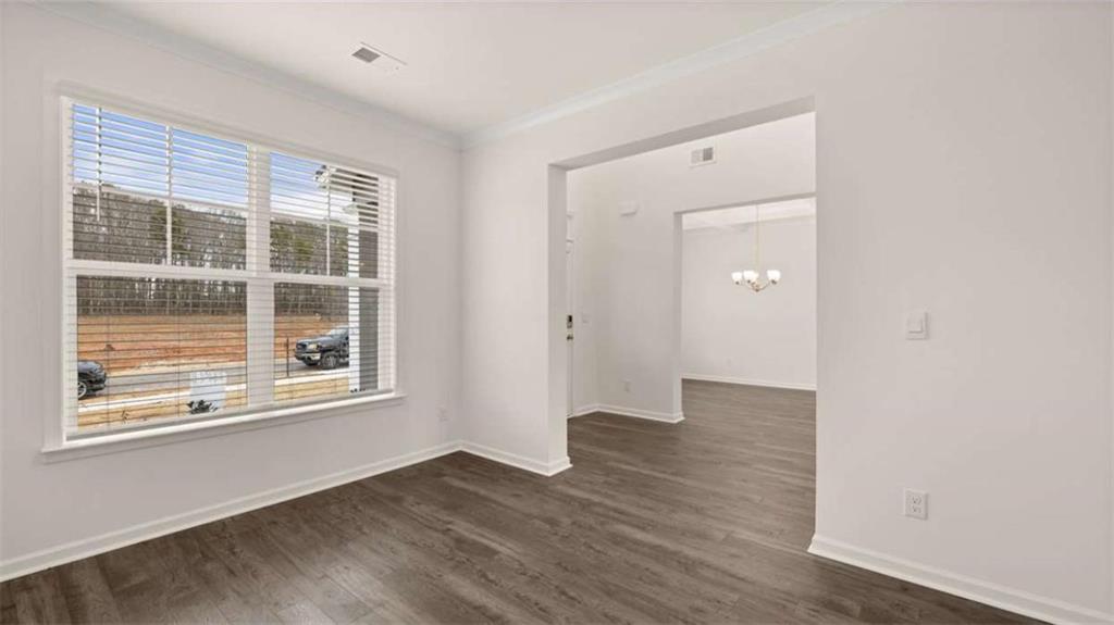 683 Edgar Hampton, GA 30228 - Photo 8 of 48 a view of an empty room with wooden floor and a window