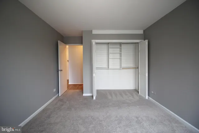 an empty room with a empty space and windows