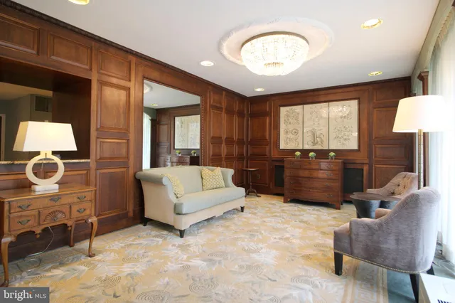 a view of living room kitchen with stainless steel appliances cabinets