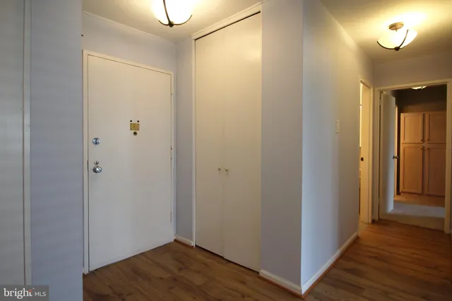 a view of a hallway with wooden floor