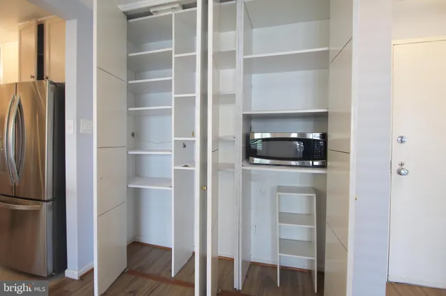 a room with a refrigerator and a stove