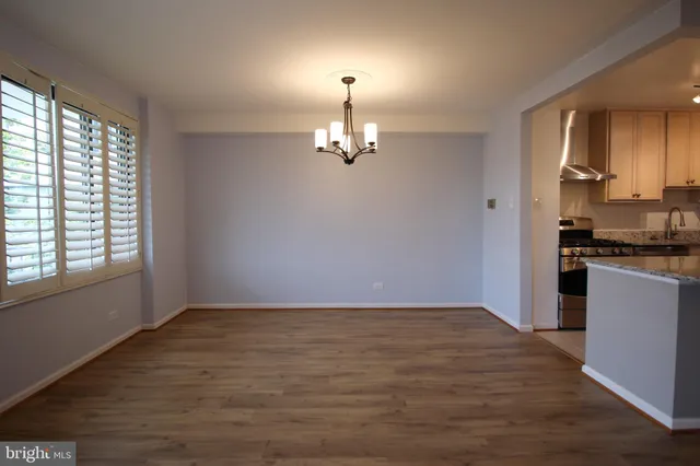 a view of a kitchen with a dishwasher cabinets and a large window