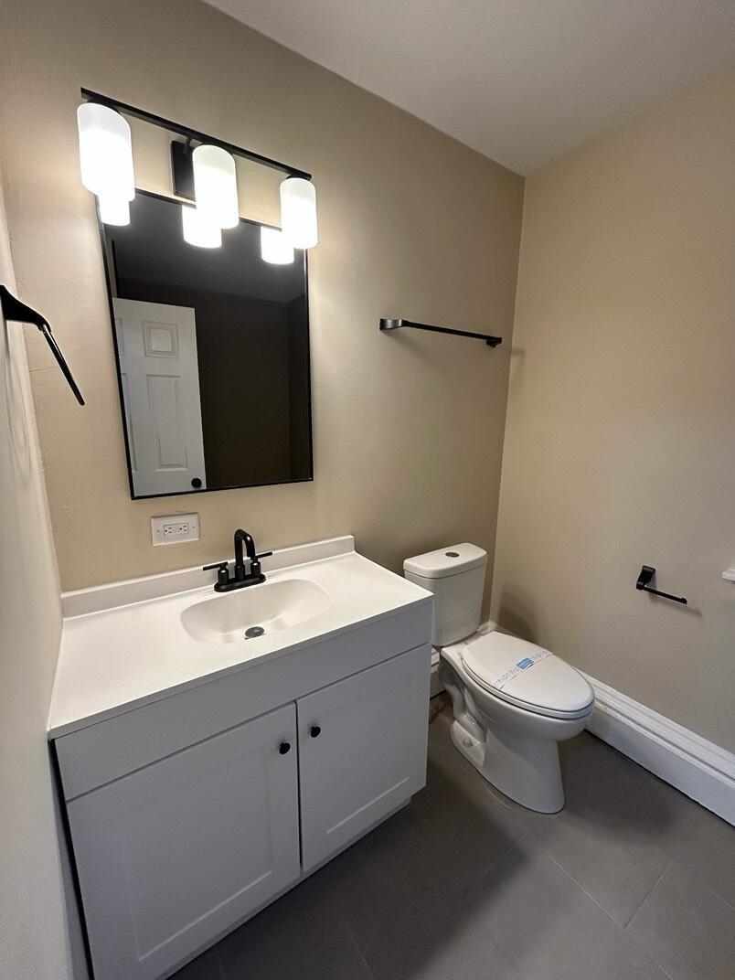 1359 State Street Hobart, IN 46342 - Photo 5 of 14 a bathroom with a toilet sink and mirror