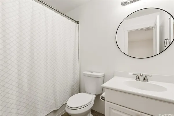 a bathroom with a toilet a sink and a mirror