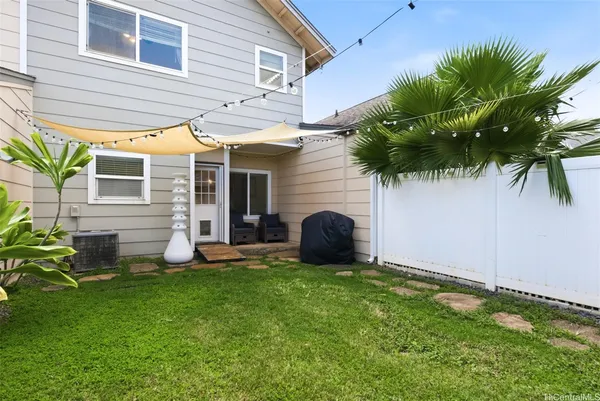 a view of a house with a yard and sitting area