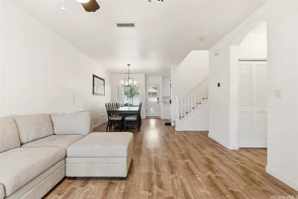 a living room with furniture and a wooden floor