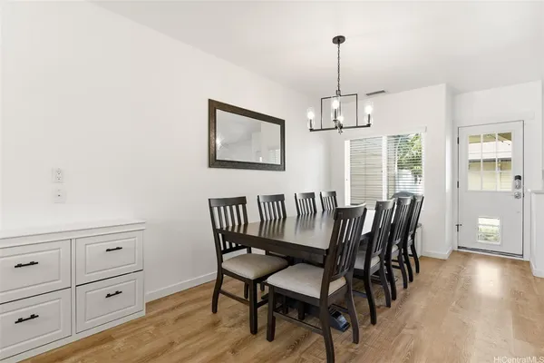 a view of a dining room with furniture window and wooden floor
