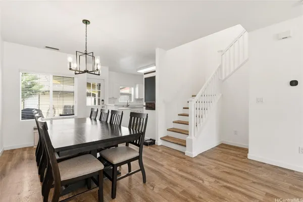 a view of a dining room with furniture window and wooden floor
