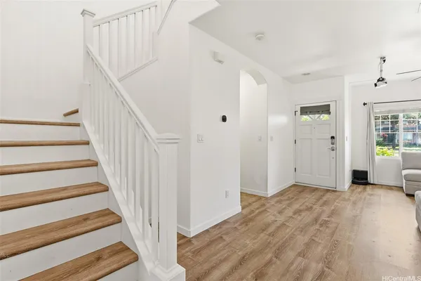 a view of a hallway with wooden floor and entryway