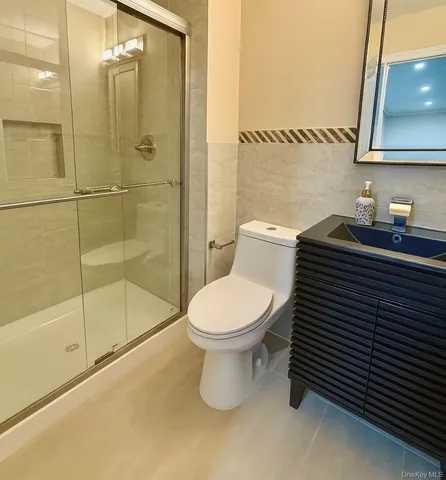a bathroom with a toilet a sink and shower