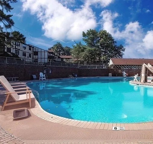 a view of a swimming pool with a yard