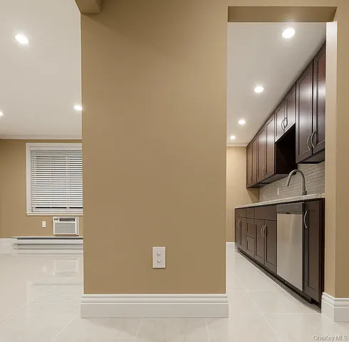 a view of a kitchen with stainless steel appliances wooden floor and a window