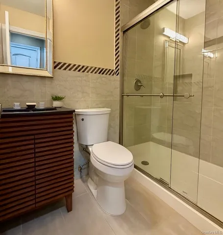 a bathroom with a toilet a sink and shower