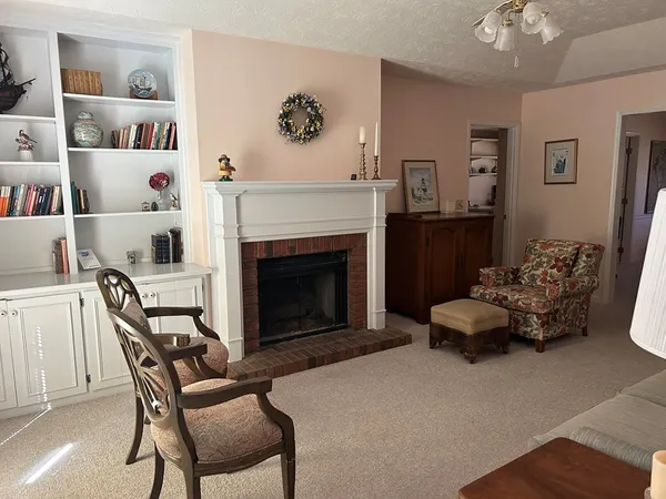 a living room with furniture and a chandelier