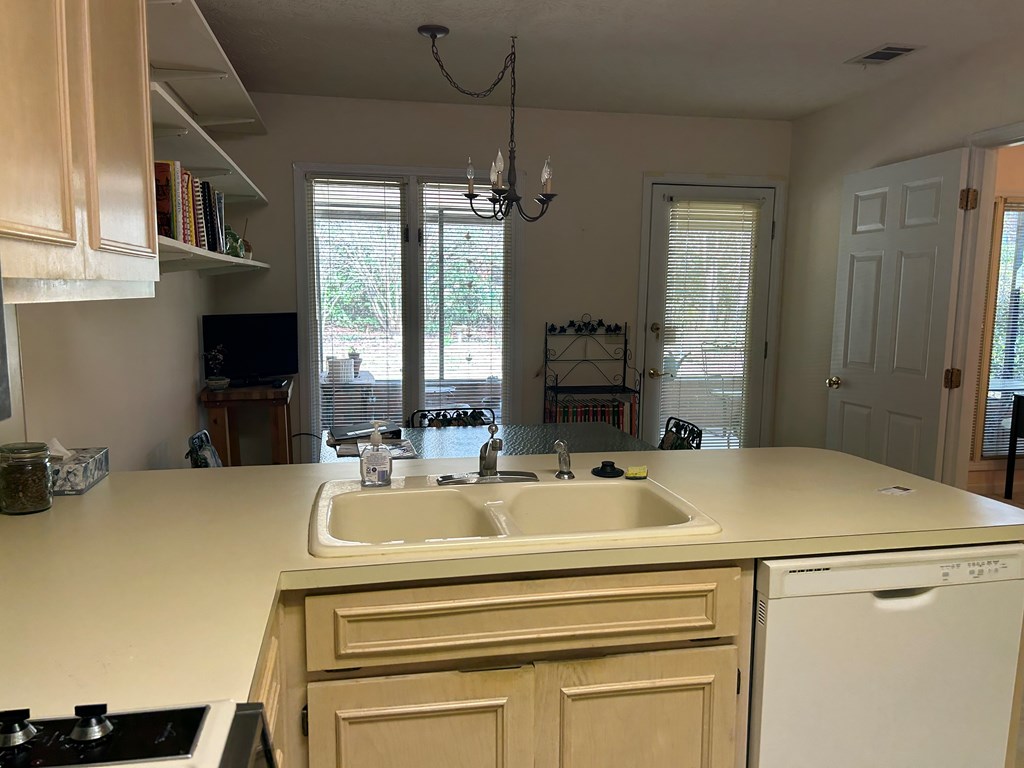 4151 Anglin Road, Unit 22C Columbus, GA 31907 - Photo 7 of 27 a room with a sink a chandelier and a flat screen tv