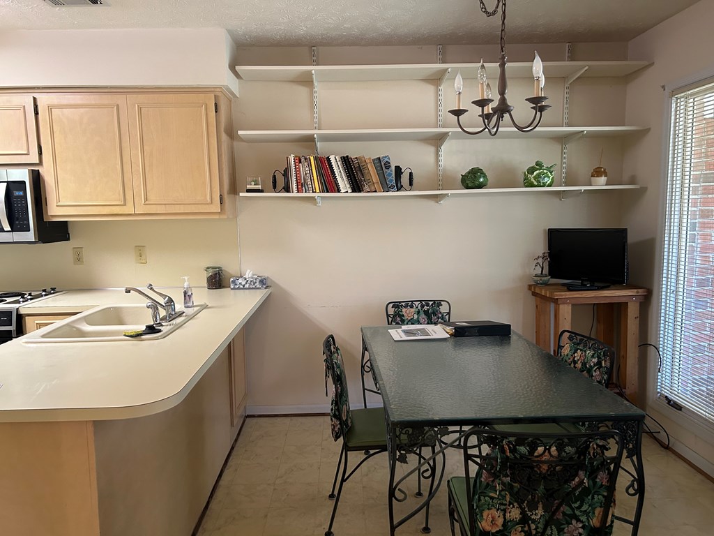 4151 Anglin Road, Unit 22C Columbus, GA 31907 - Photo 8 of 27 a kitchen with a table and cabinets