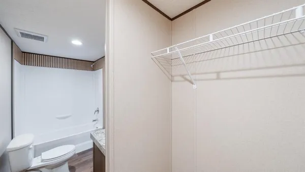 a bathroom with a shower a toilet and sink