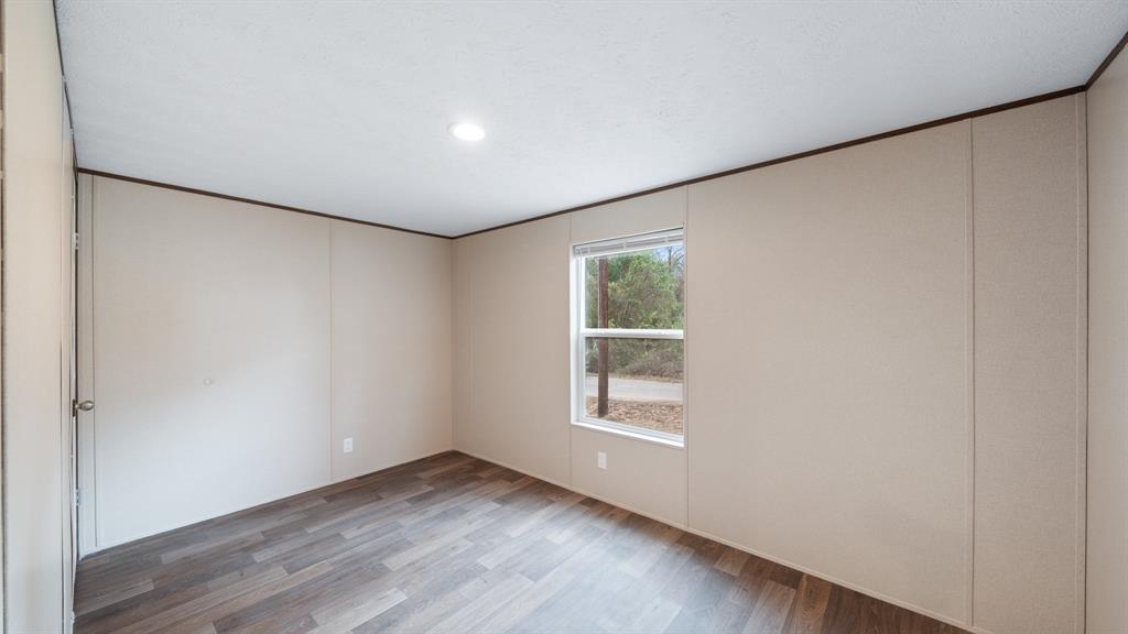 721 Queens Drive Tool, TX 75143 - Photo 15 of 30 an empty room with wooden floor and windows