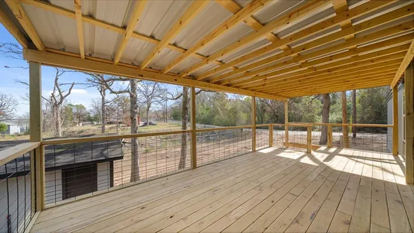 a view of porch with wooden floor
