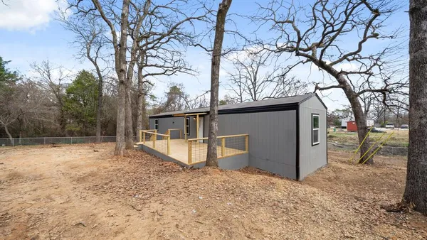 a view of a house with a yard covered in snow