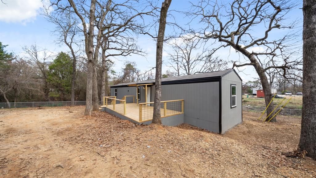 721 Queens Drive Tool, TX 75143 - Photo 3 of 30 a view of a house with a yard covered in snow