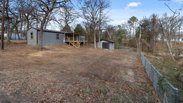 a view of a house with a yard and tree