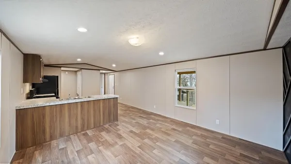 a view of a kitchen with a sink and a refrigerator