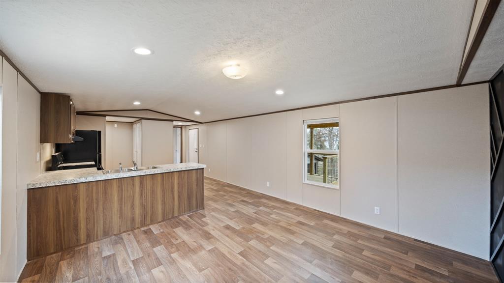 721 Queens Drive Tool, TX 75143 - Photo 5 of 30 a view of a kitchen with a sink and a refrigerator