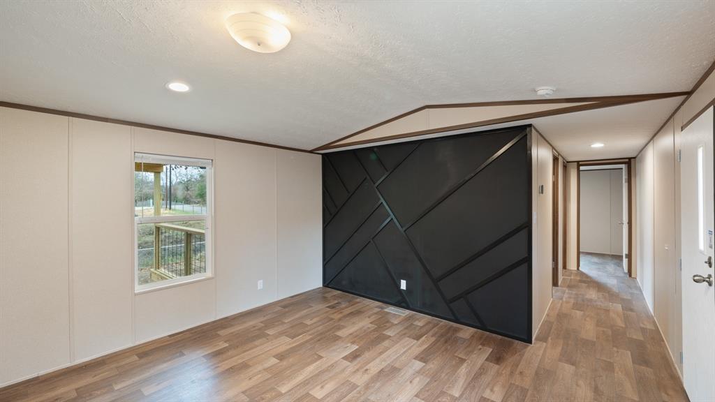 721 Queens Drive Tool, TX 75143 - Photo 8 of 30 a view of an empty room with wooden floor and a window