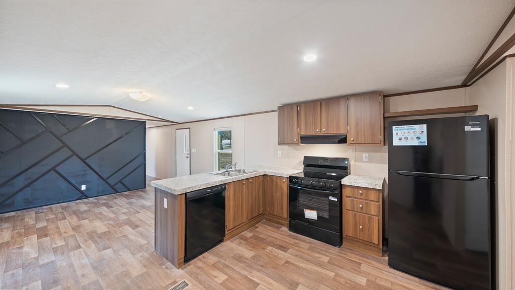 721 Queens Drive Tool, TX 75143 - Photo 9 of 30 a kitchen with stainless steel appliances granite countertop a refrigerator and a stove top oven