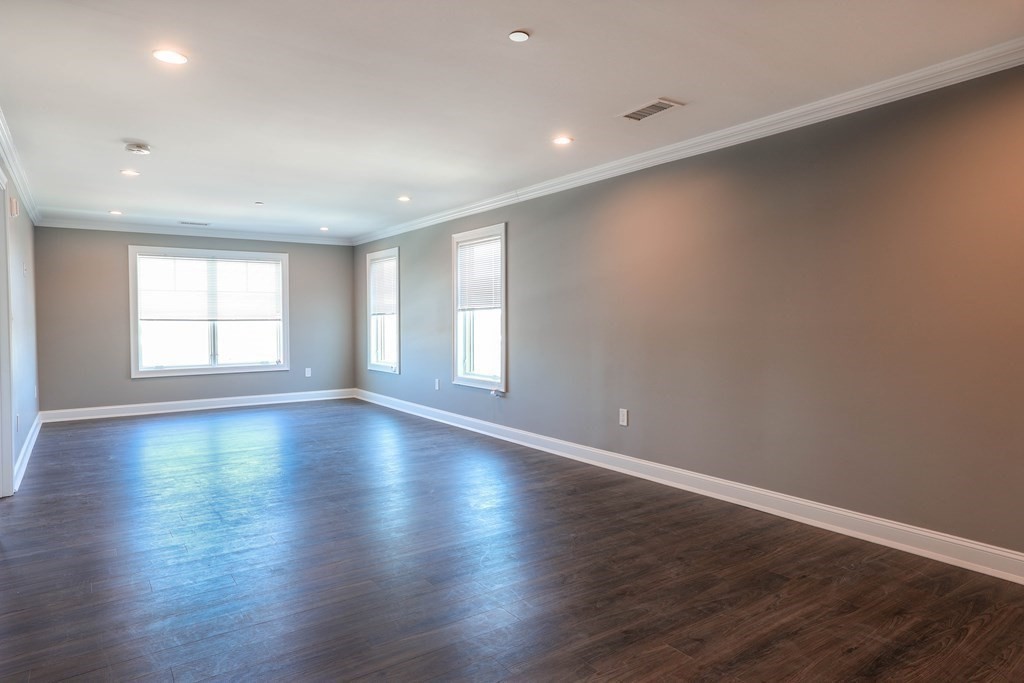 918 Providence Highway, Unit 314 Dedham, MA 02026 - Photo 3 of 10 a view of empty room with wooden floor and fan