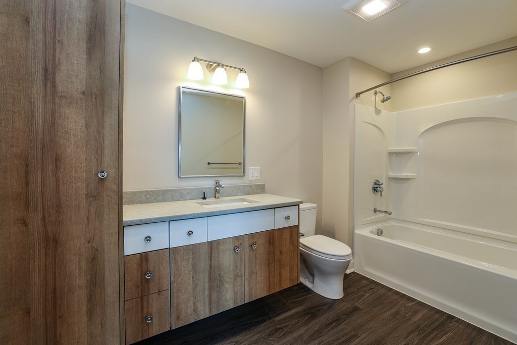 918 Providence Highway, Unit 314 Dedham, MA 02026 - Photo 8 of 10 a bathroom with a sink a toilet and shower