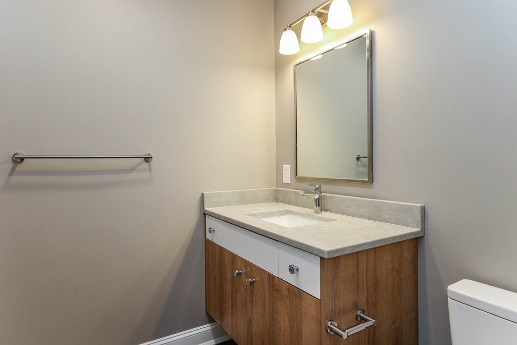 918 Providence Highway, Unit 314 Dedham, MA 02026 - Photo 9 of 10 a bathroom with a sink and a mirror