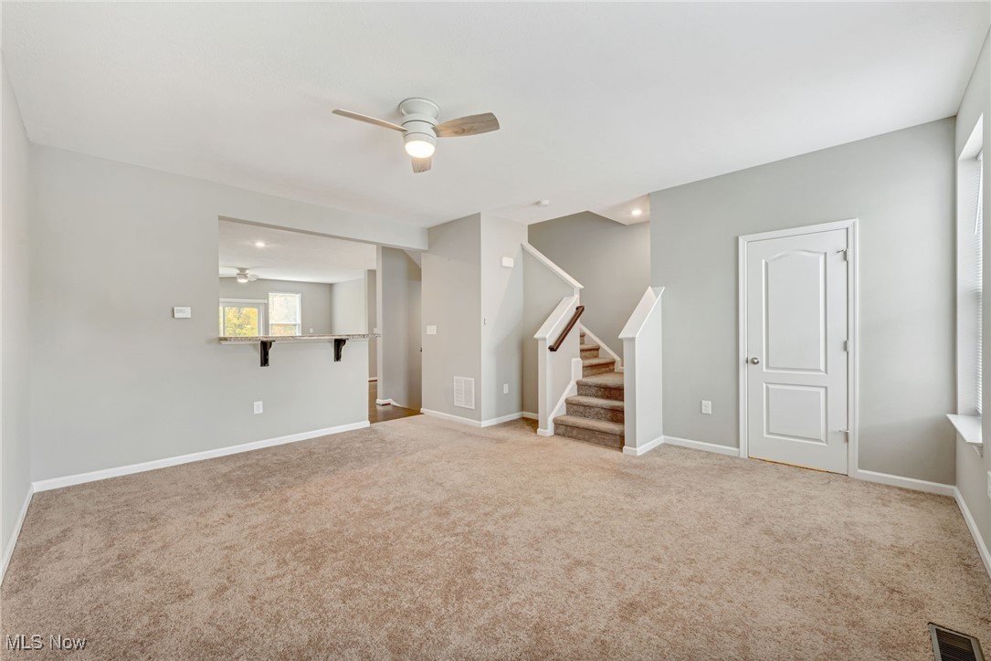 134 Inlet Street Morgantown, WV 26508 - Photo 17 of 44 Living Room with Access to Half Bathroom and Upper Level and Additional Bar Seating for Kitchen