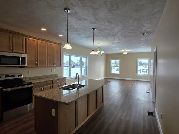 a kitchen with sink cabinets and wooden floor