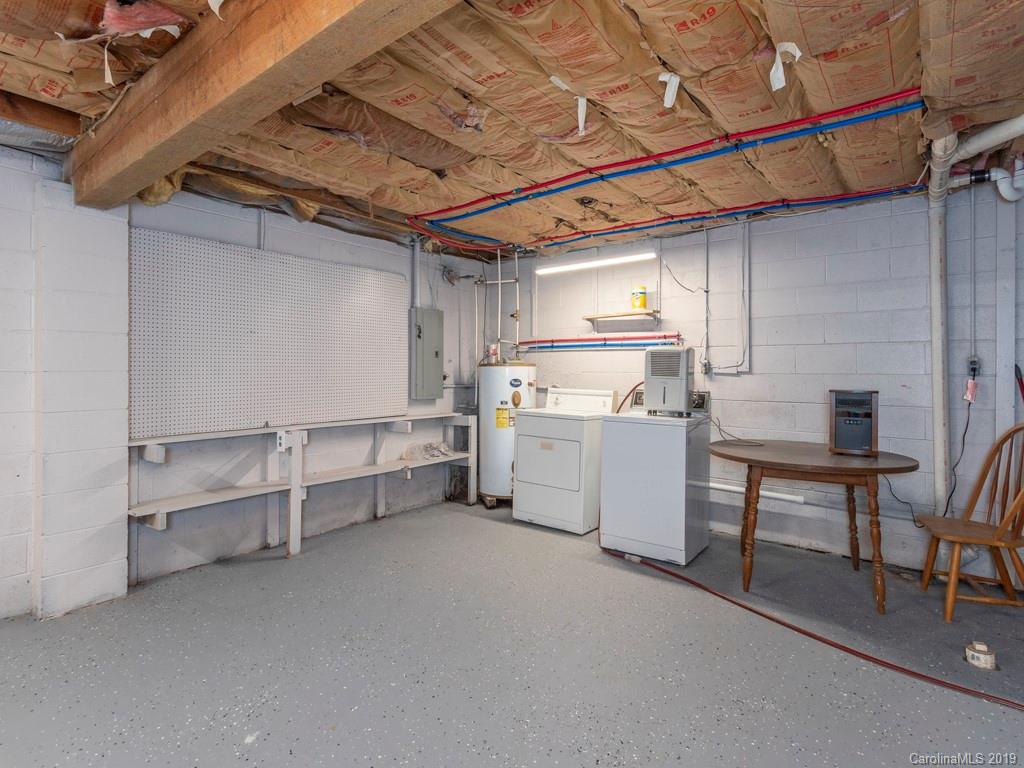119 Loop Road Clyde, NC 28721 - Photo 17 of 18 a utility room with cabinets dryer and washer