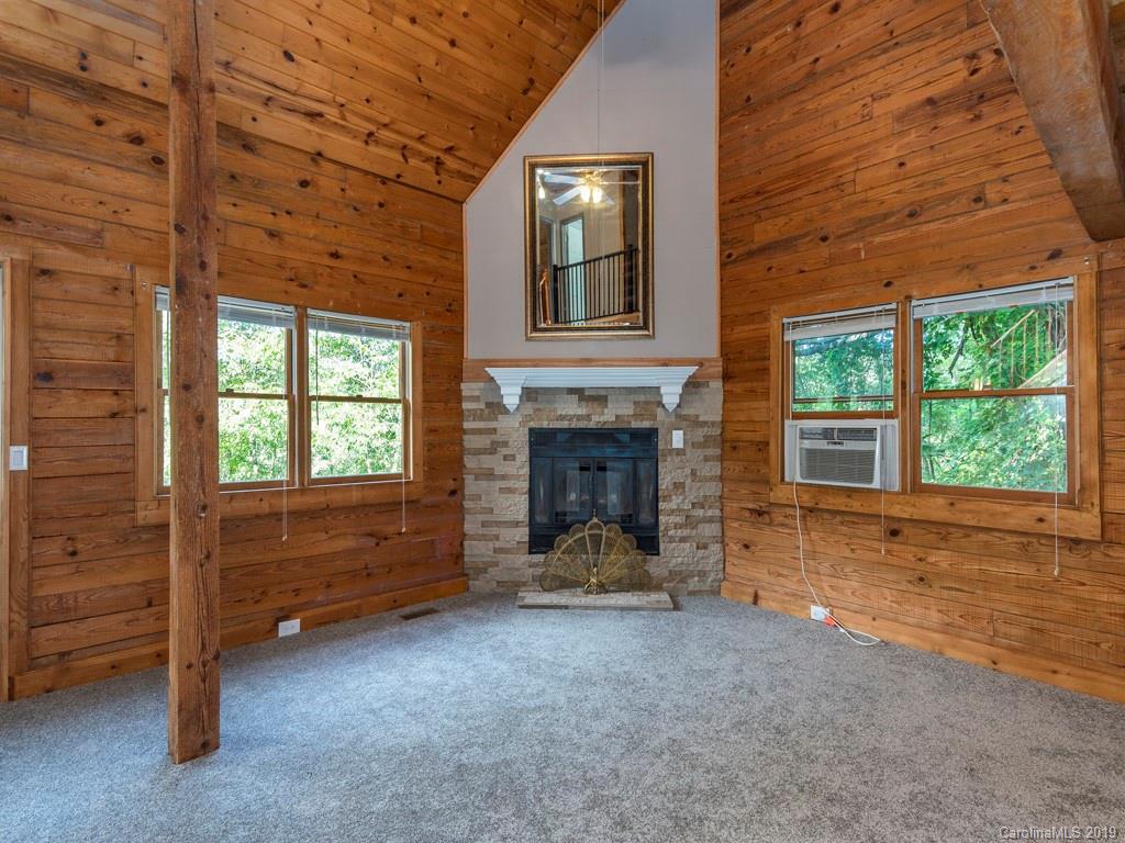 119 Loop Road Clyde, NC 28721 - Photo 4 of 18 a view of an empty room with a fireplace and a window