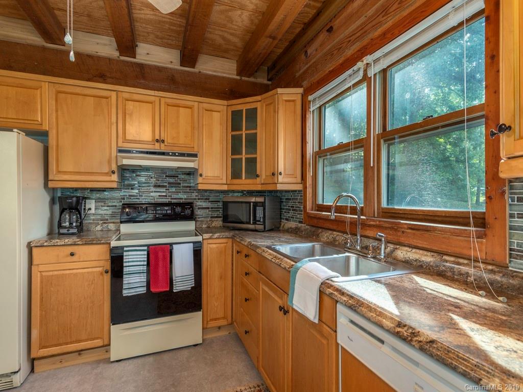 119 Loop Road Clyde, NC 28721 - Photo 7 of 18 a kitchen with stainless steel appliances granite countertop a sink stove and cabinets