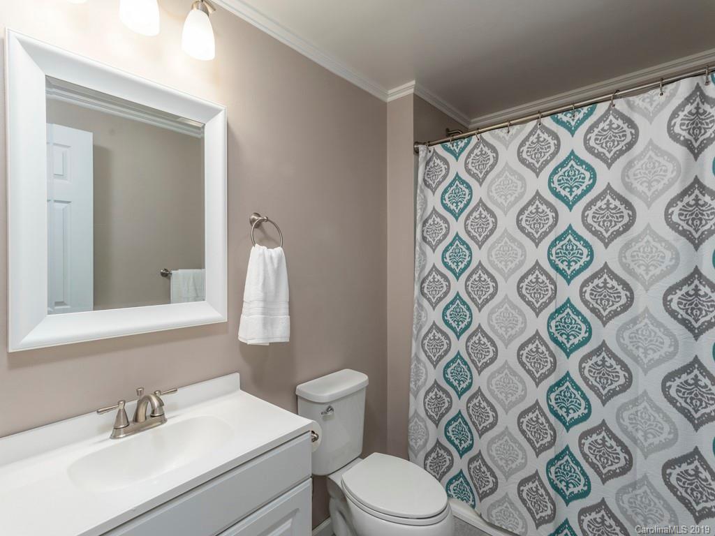 119 Loop Road Clyde, NC 28721 - Photo 10 of 18 a bathroom with a sink mirror vanity and toilet
